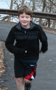 Bryce running up a hill at his first 5k in DEC 2011.